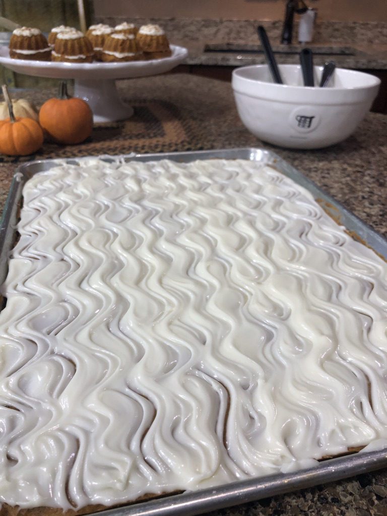 pan of pumpkin bars with maple cream cheese frosting 