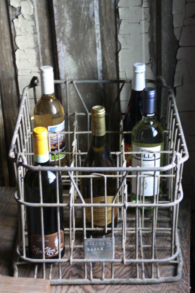 vintage dairy crate used to hold wine bottles