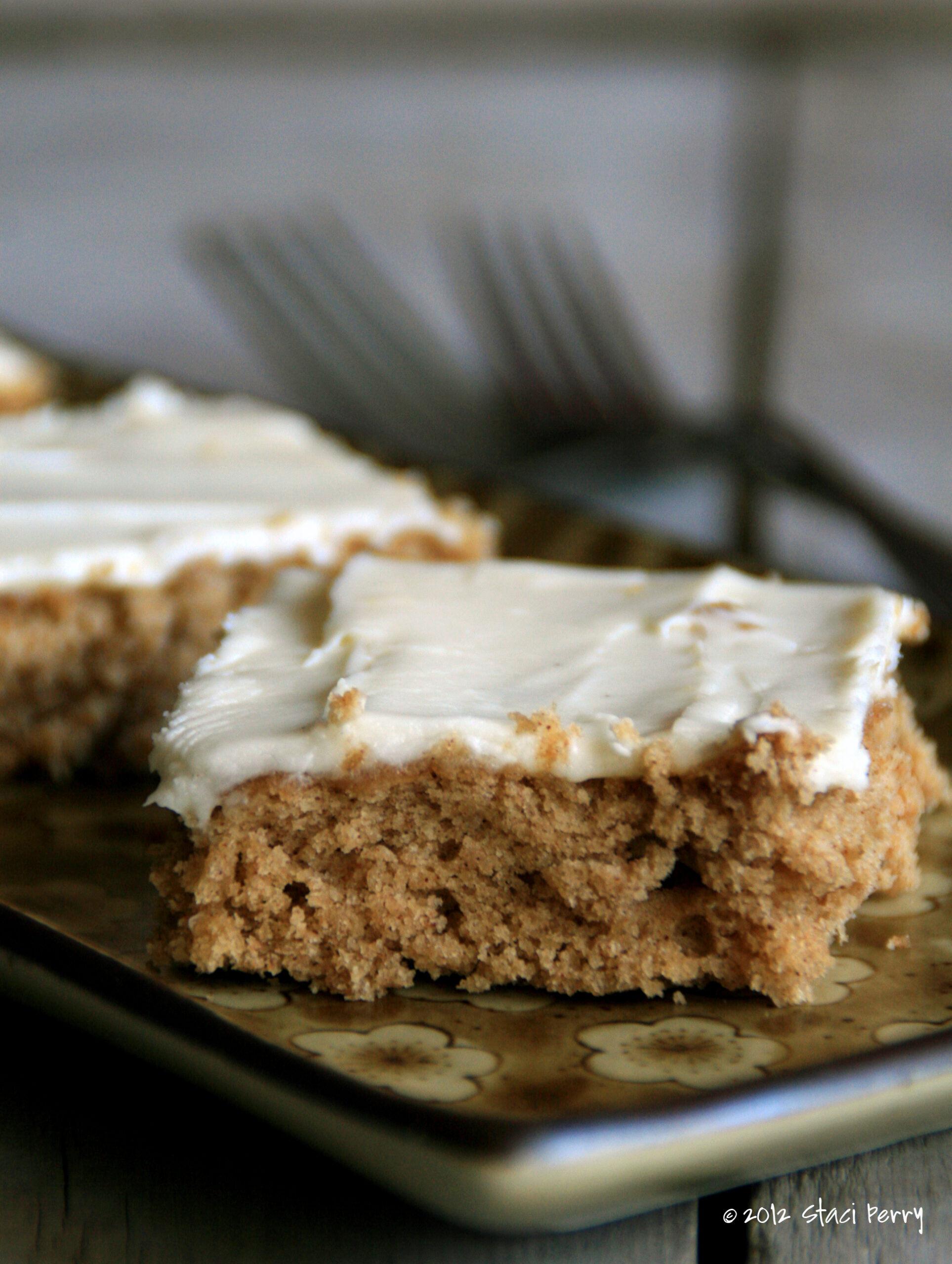 cinnamon banana bars cream cheese frosting on a small tray