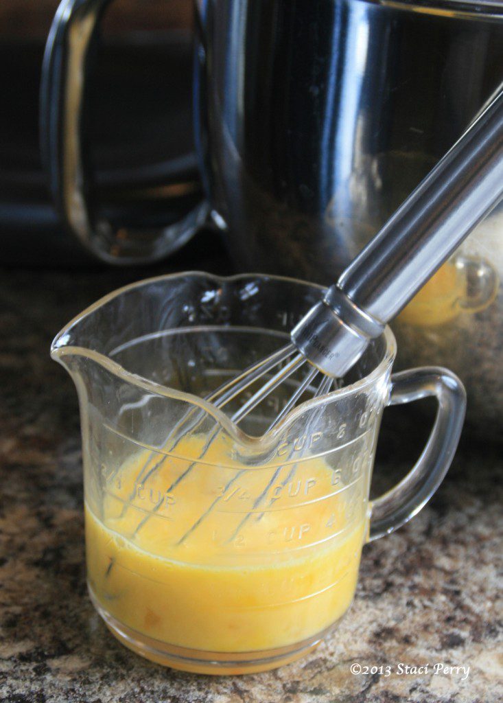 2 beaten eggs with a whisk in a measuring cup