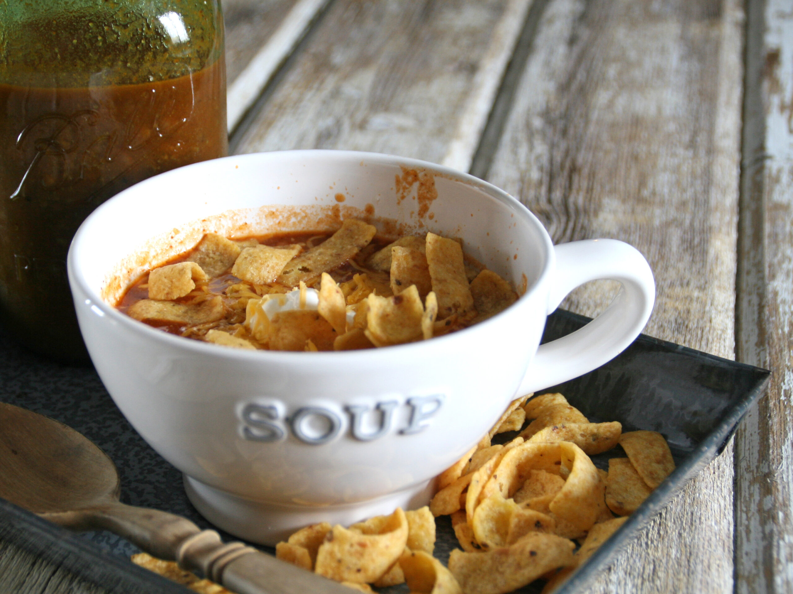 bowl of beer chili with corn chips on the side