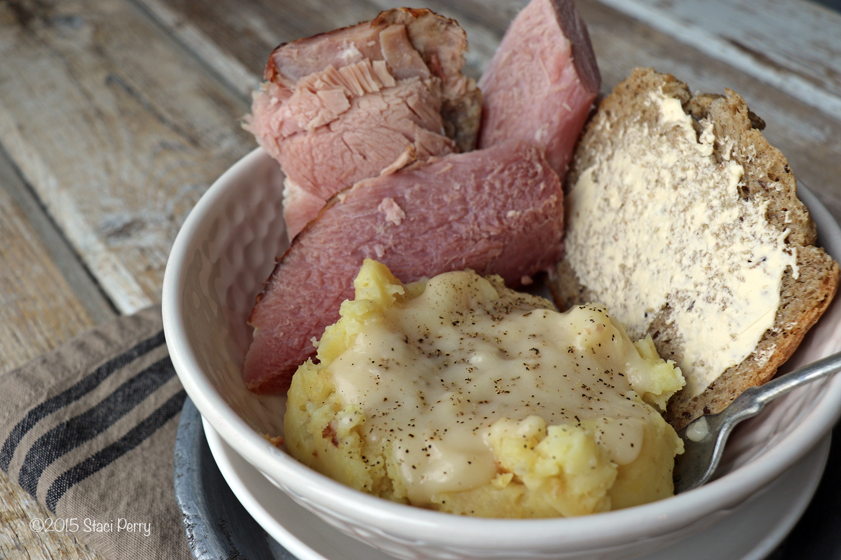 bowl of ham, bread and mashed potatoes with ham gravy