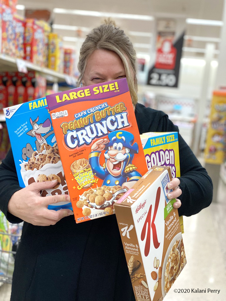 lady holding four boxes of cereal