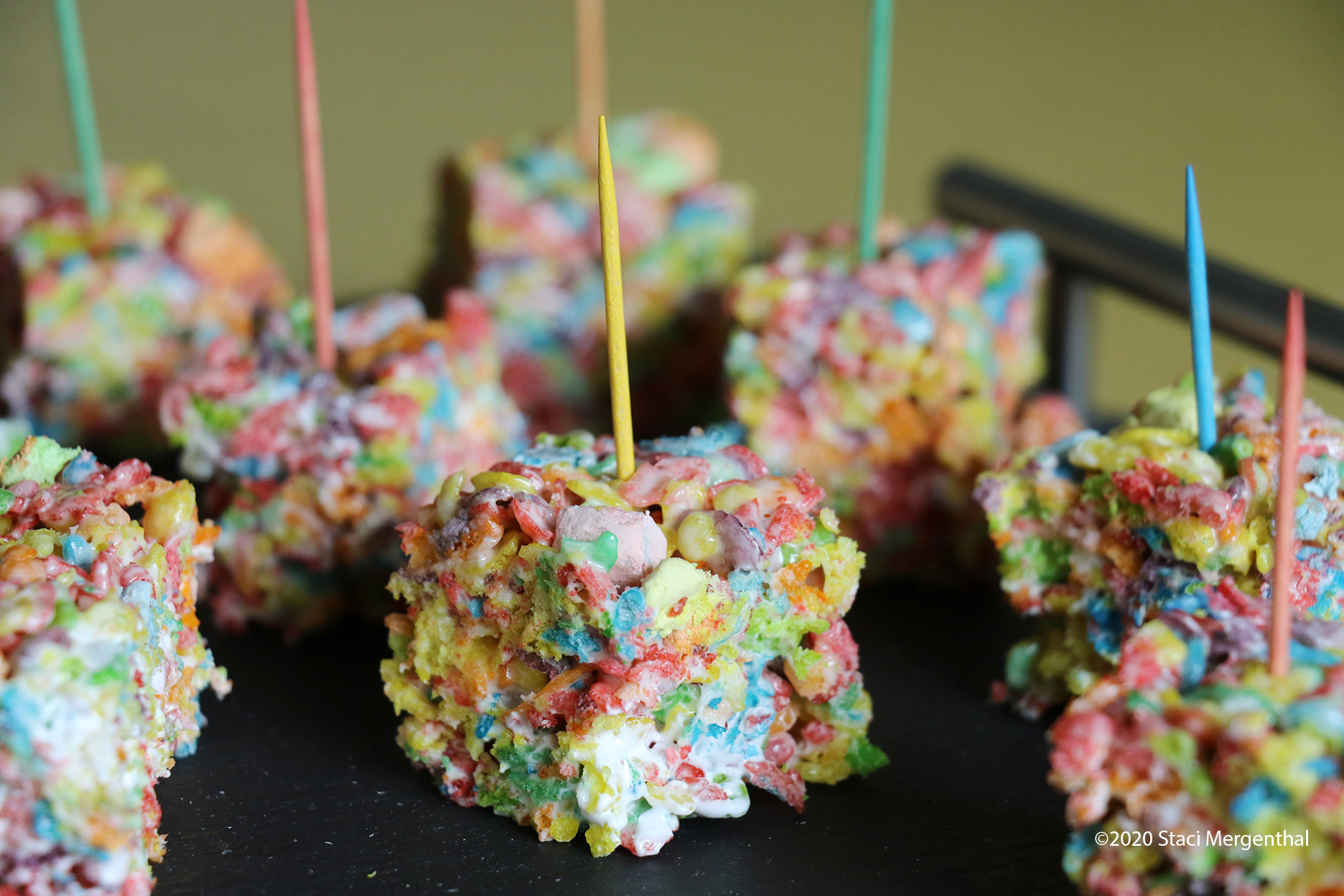 Fruity PEBBLES cereal bars with marshmallows with colored toothpicks stuck on top