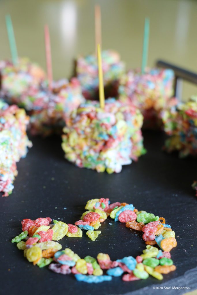 Fruity PEBBLES bars with colored toothpicks and heart made of Fruity PEBBLES cereal