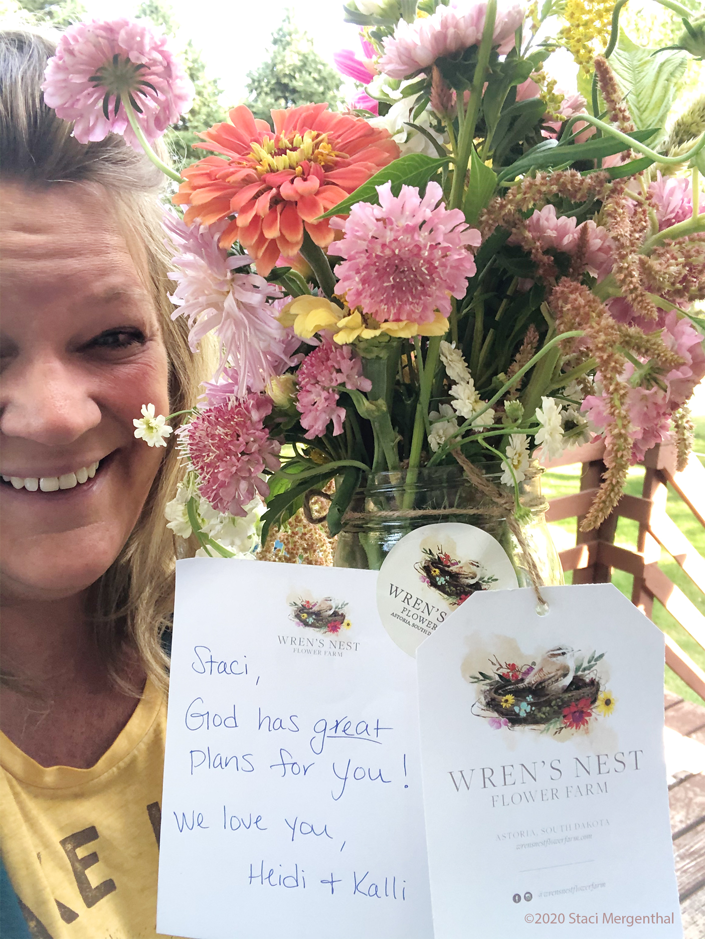 lady holding flowers and a note from her sisters