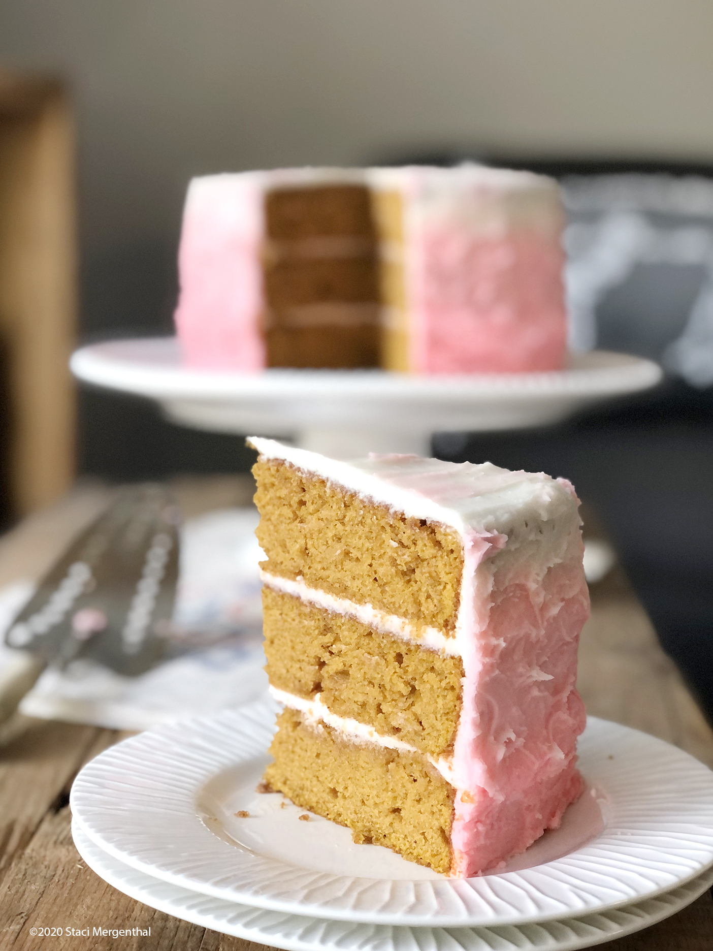 slice of 2-layer pumpkin cake with maple buttercream frosting