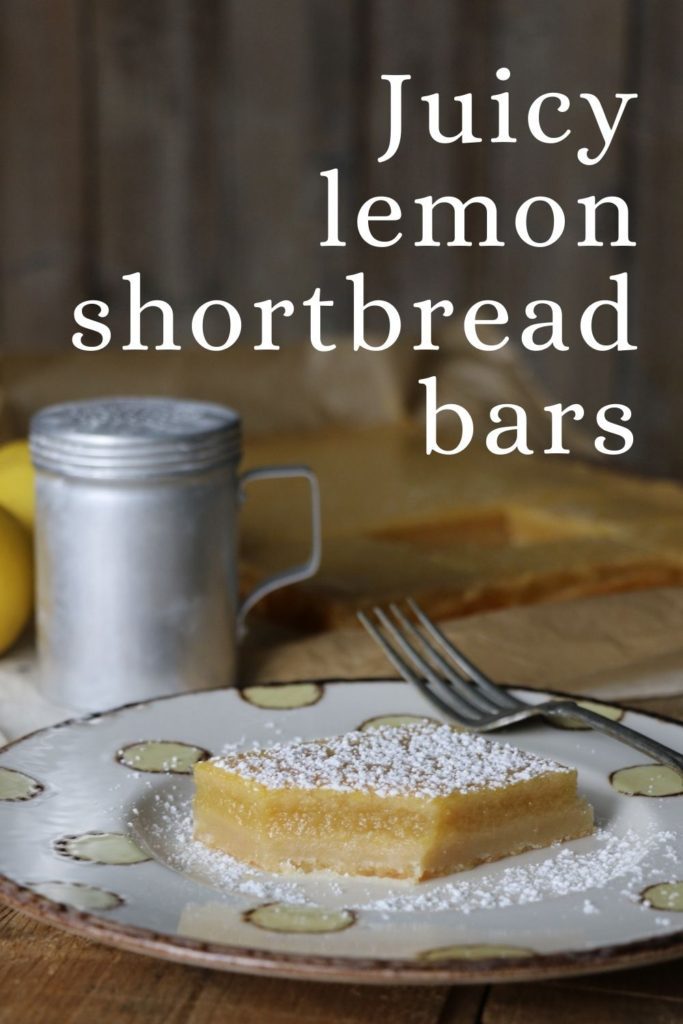 juicy lemon bar with shortbread crust on a plate 