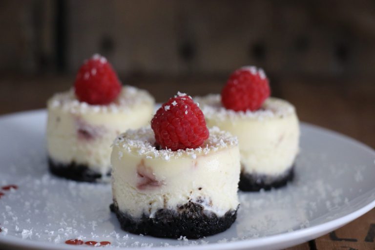 3 individual white chocolate raspberry truffle cheesecake on a plate