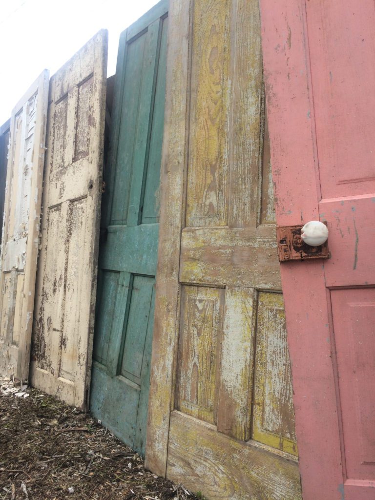 row of old doors with pastel colors chippy paint