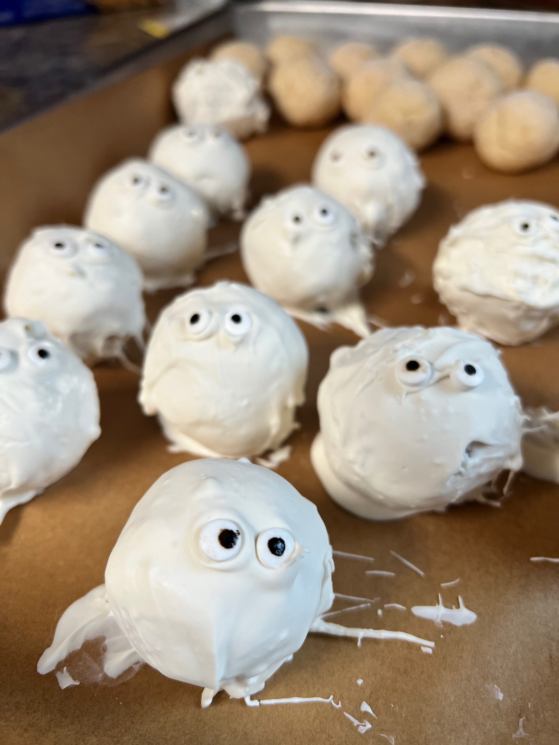 mummy cake balls with first layer of almond bark and eyeballs