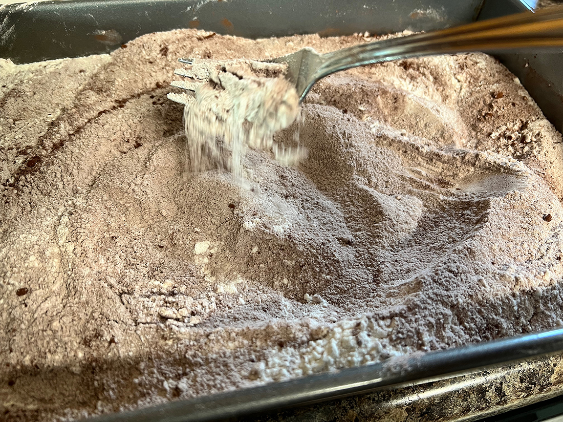 pan with flour ingredients stirring with fork 