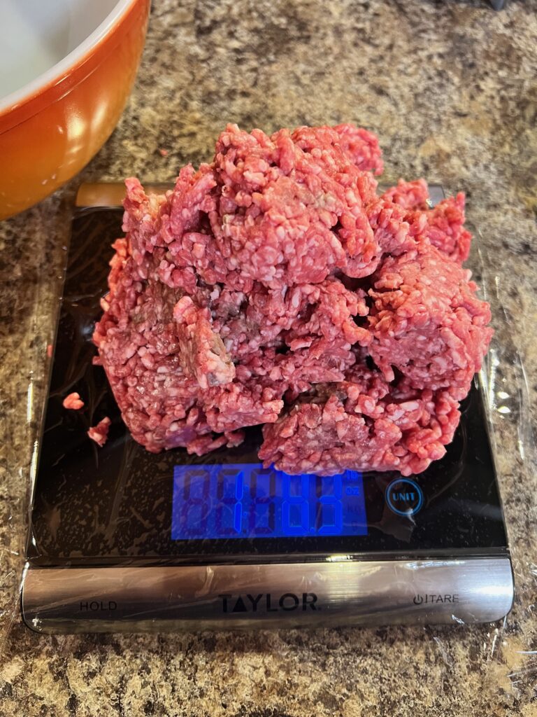 1 and a half pounds of ground beef on a scale for meatloaf 