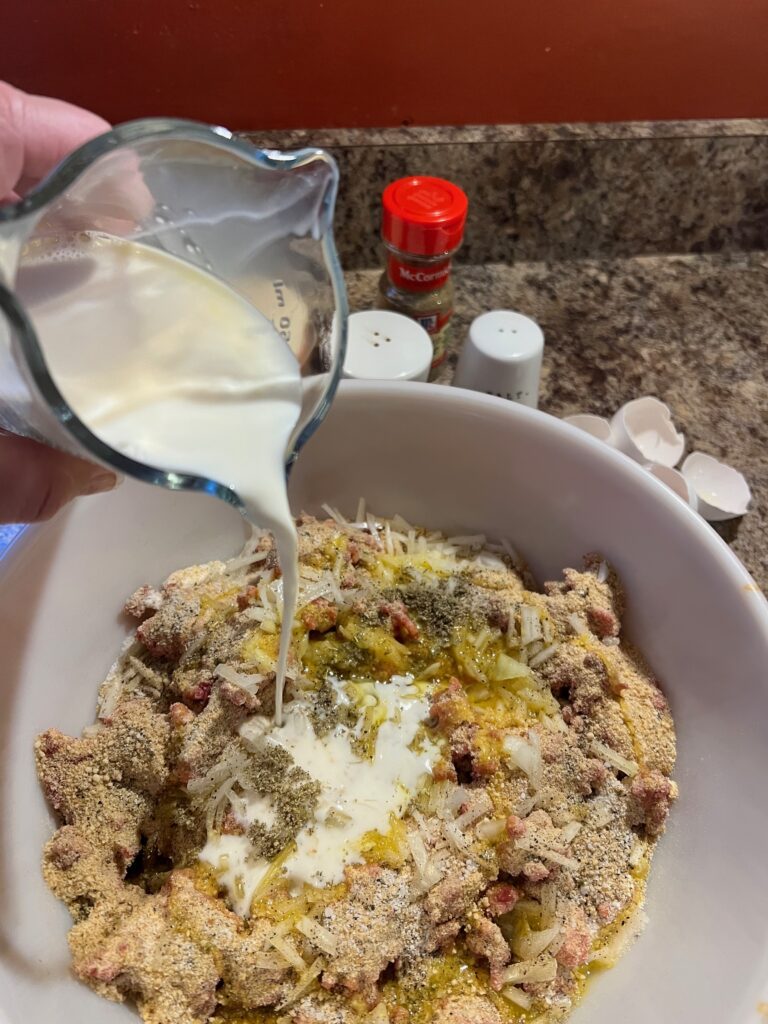 milk added to meatloaf mixture in a bowl