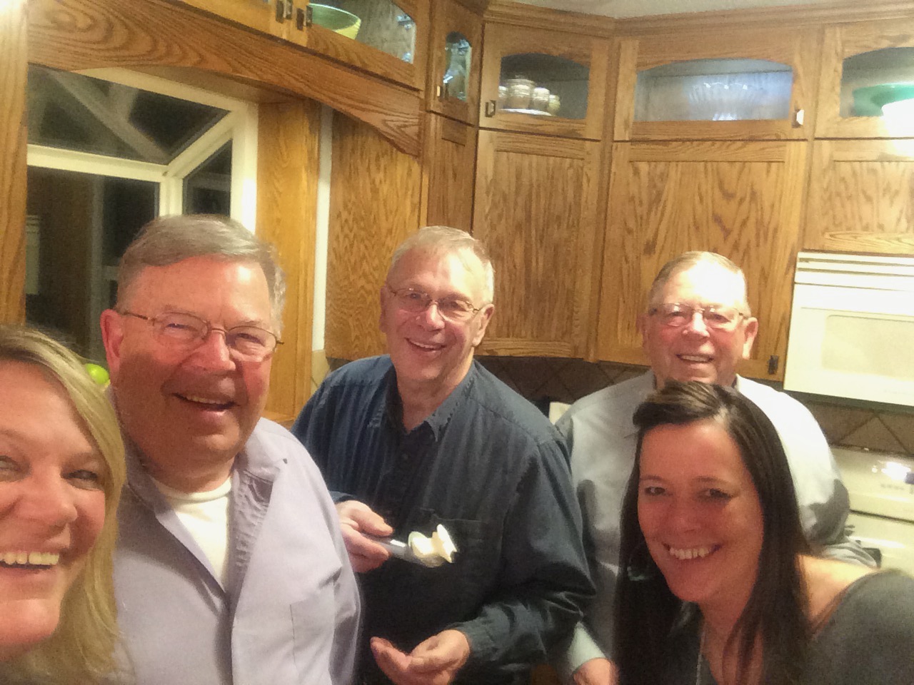 dad holding scoop of homemade ice cream with brothers and daughters