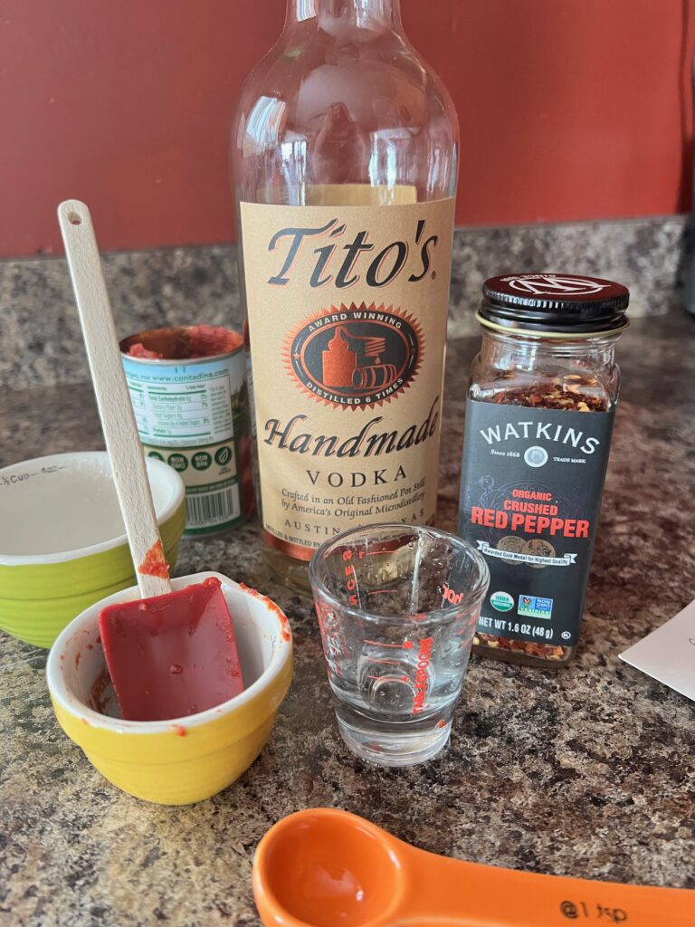 bottle of Titos vodka and red pepper flakes 