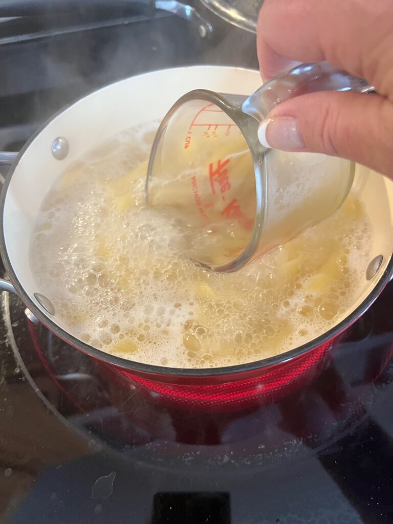 remove some of the hot pasta water before draining 