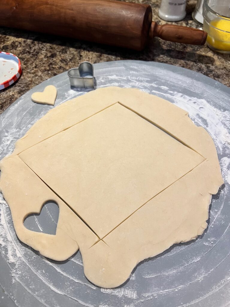 cutting out a big diamond and tiny heart