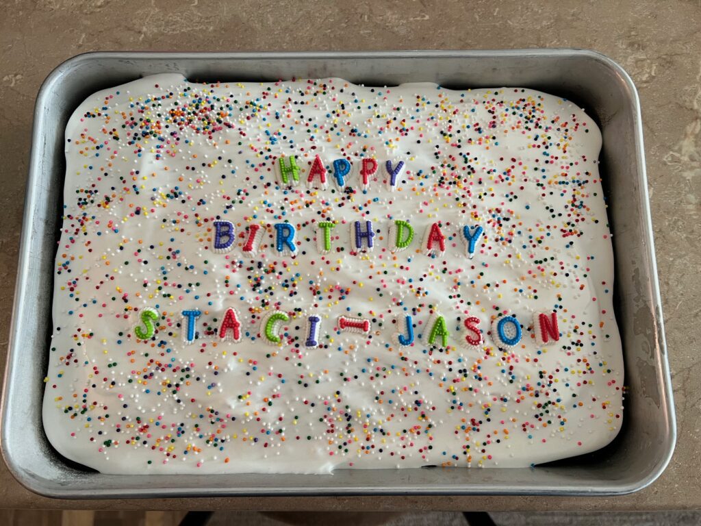 9x13 cocoa fudge birthday cake with letters that say happy birthday Staci and Jason