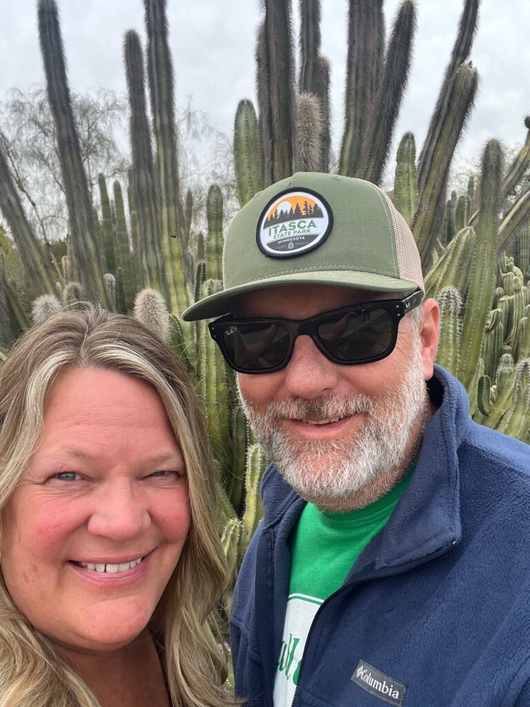 Staci and Jason in front of a large cactus at Desert Botanical Garden Arizona 