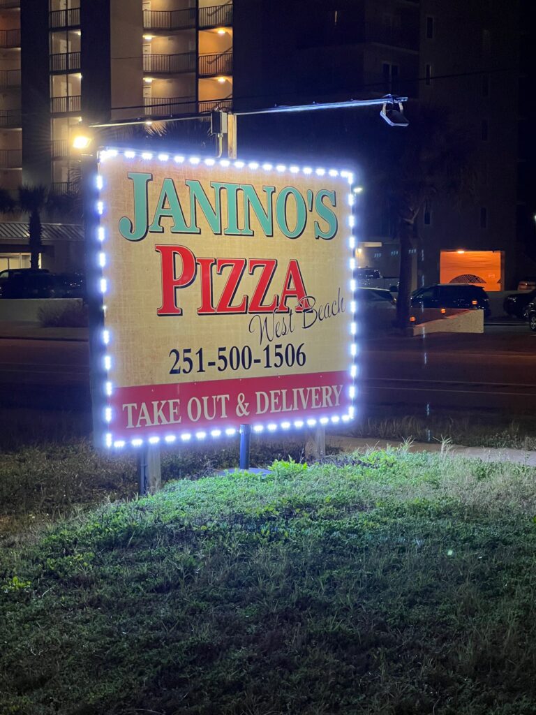 Janino's Pizza sign at nighttime