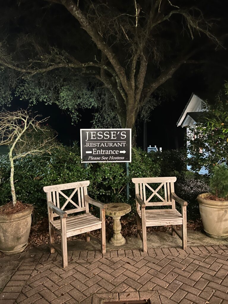 two chair sitting outside at night at Jesse's Restaurant