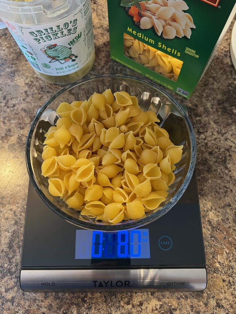 measuring dry pasta on an electronic kitchen scale