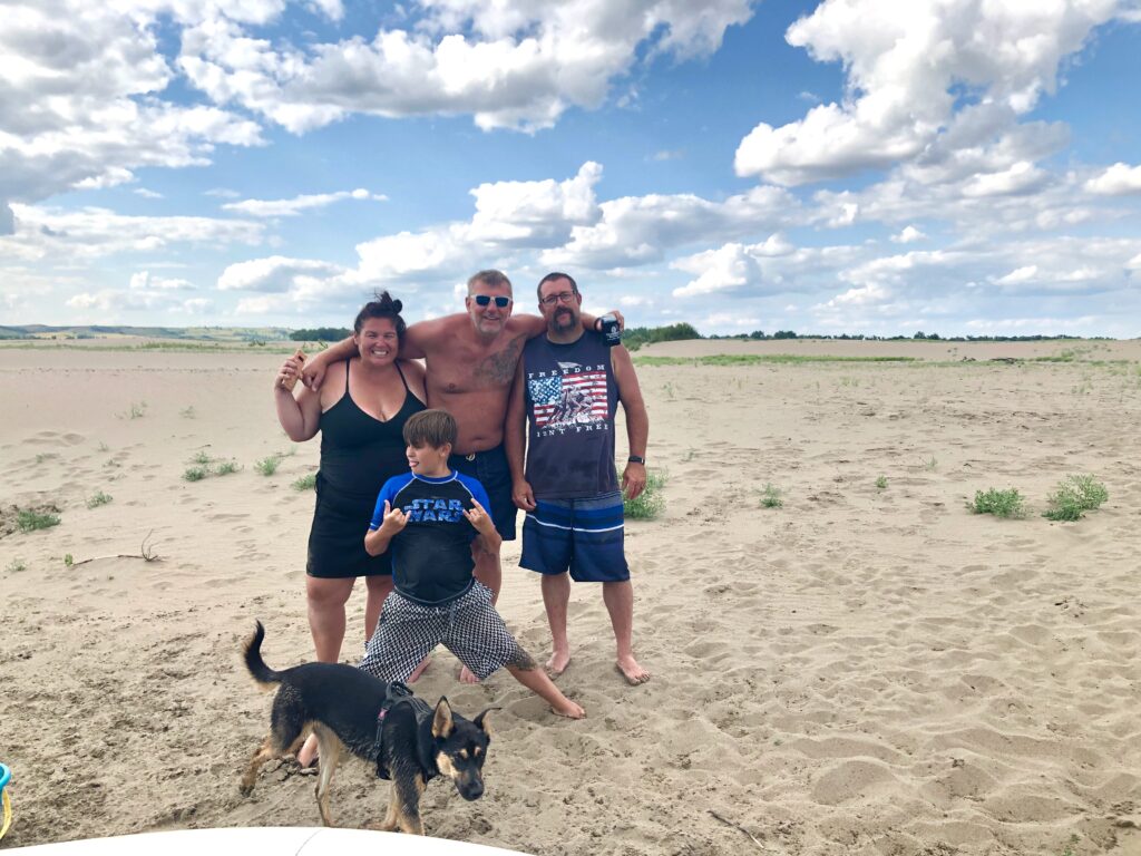 family and a dog on a sandbar on the Missouri River near Mandan North Dakota 