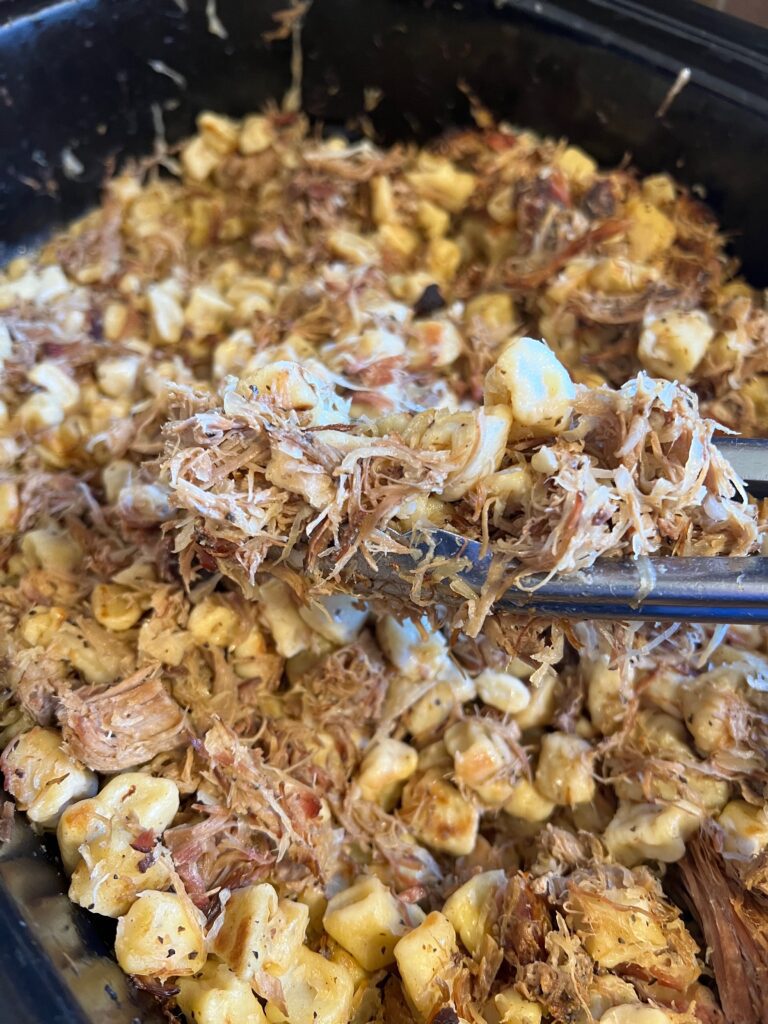 crockpot full of smoked pulled pork and sauerkraut with fried knoephla 