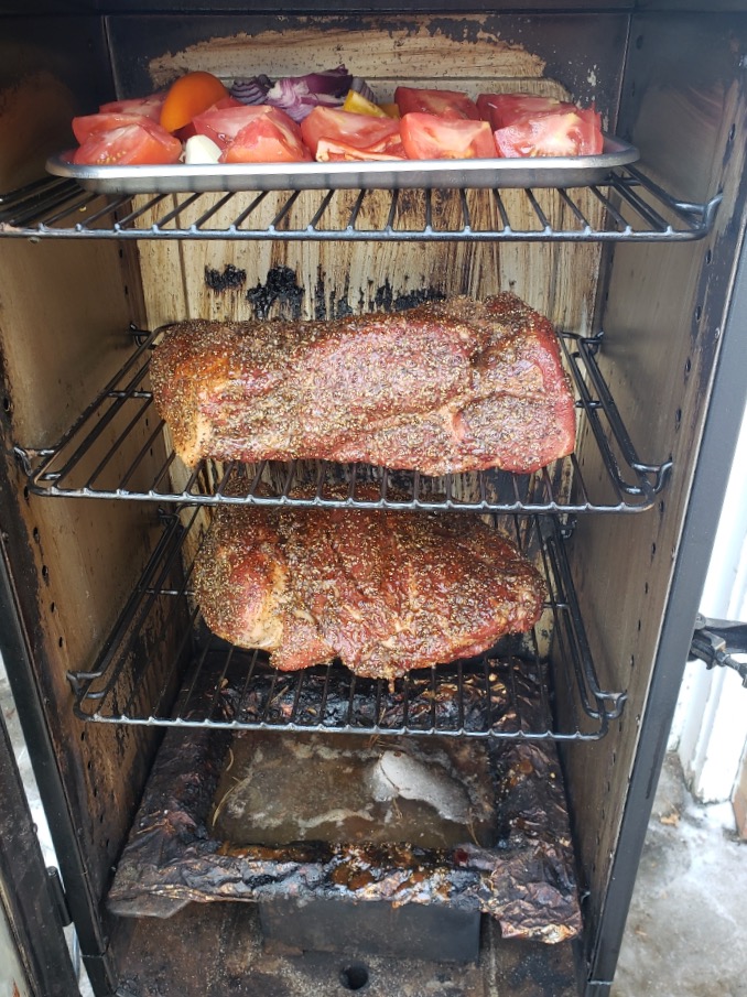 meats and vegetables in smoker