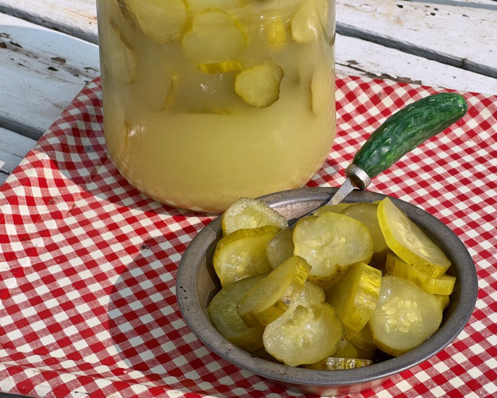 jar of horseradish pickles and a little dish with pickles and a pickle fork