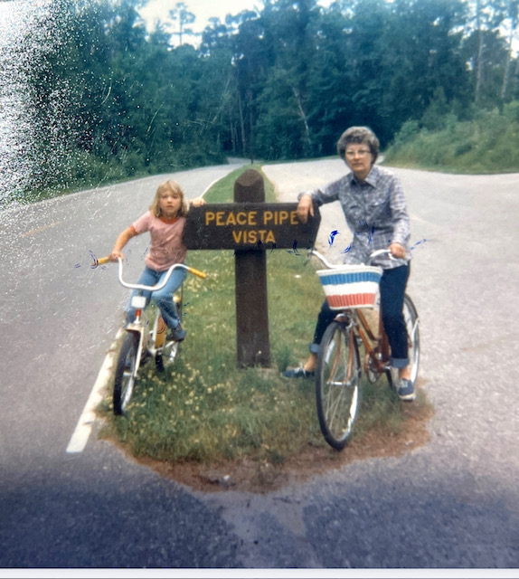 childhood Jenn and Grandma Henkel by Peace Pipe Vista sign at Itasca State Park