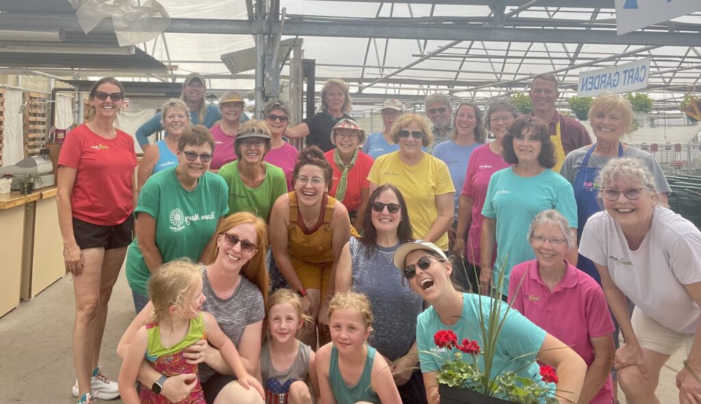 Medary Acres Greenhouse Staff and three children in the greenhouse