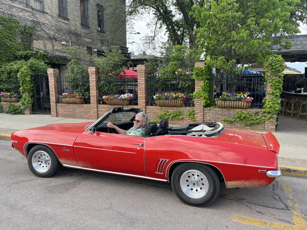 Brian Darnall in a red Camaro