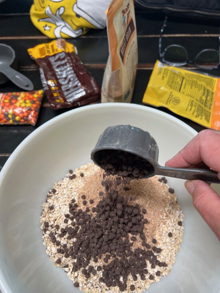 adding mini chocolate chips to bowl