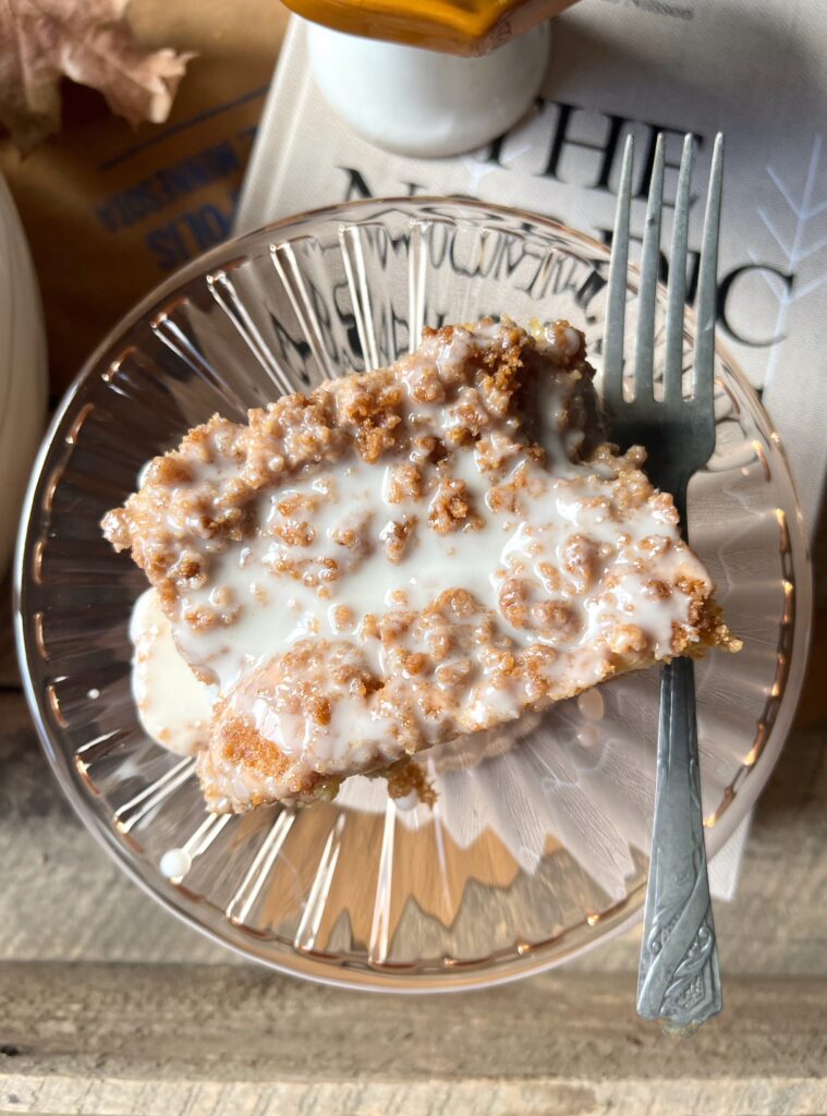 pink glass plate with slice of graham coffee cake and fork