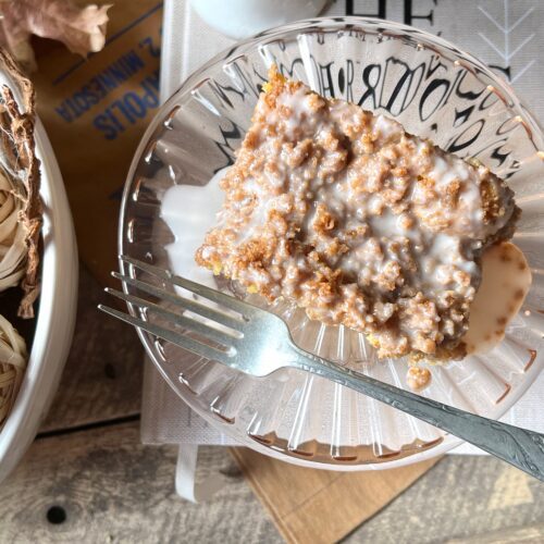 pink glass plate with slice of graham coffee cake and fork