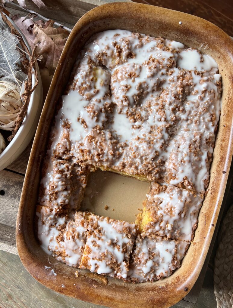 9x13 pan of graham coffee cake with one piece out of the middle