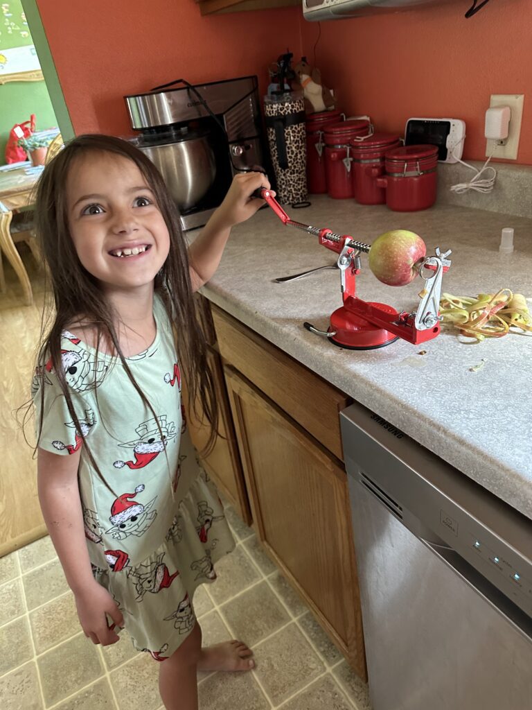 Carly smiling with apple peeler
