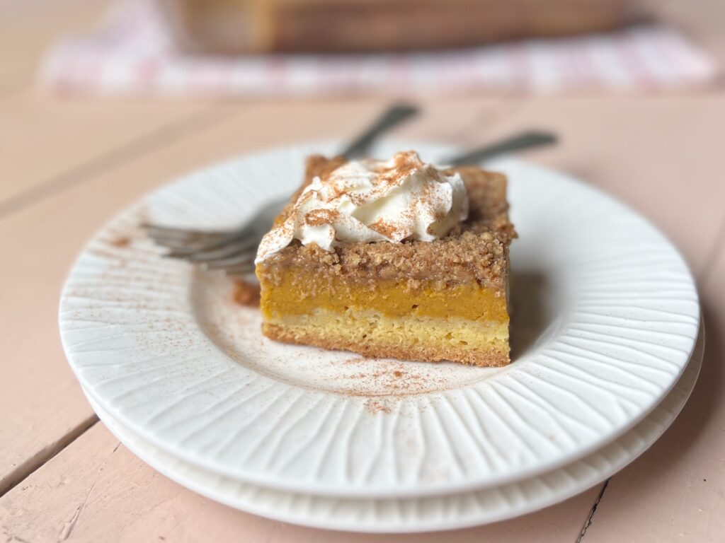 piece of pumpkin dessert on a plate with forks