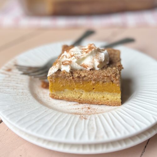 piece of pumpkin dessert on a plate with forks