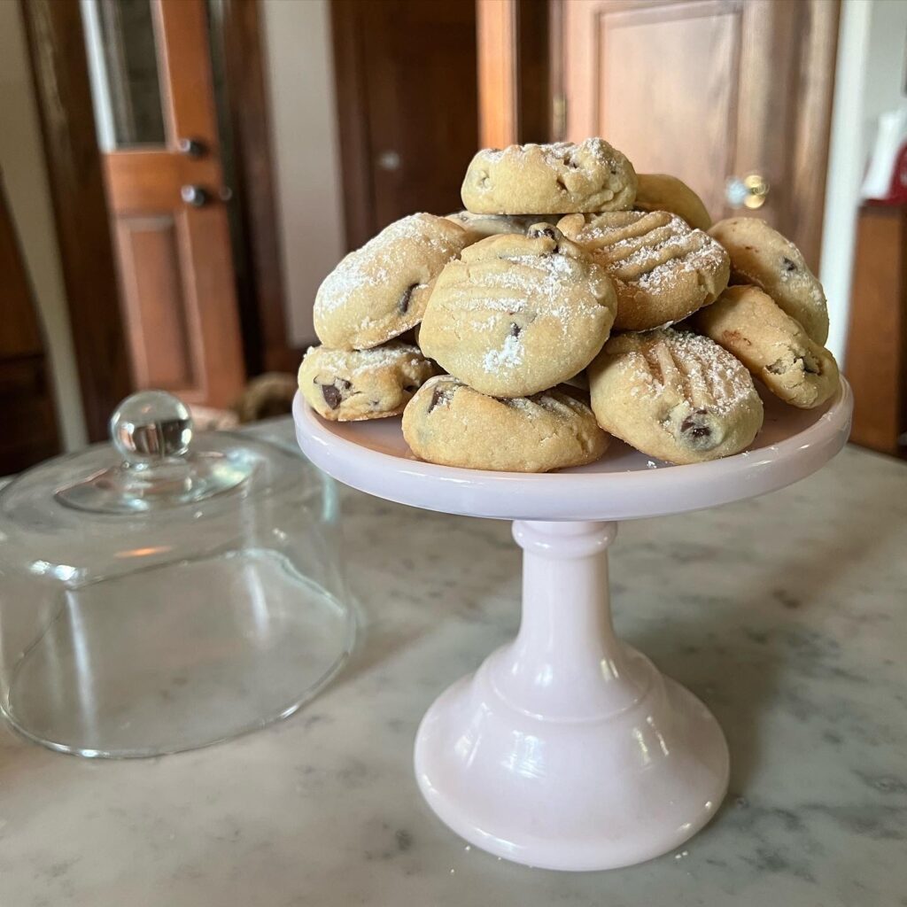 tall cake stand piled with chocolate chip shortbread cookies