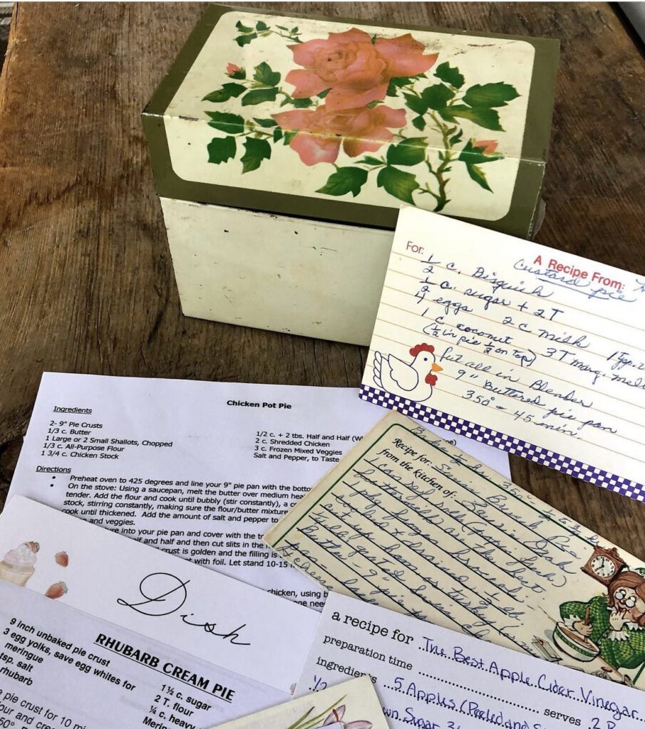 Sarah's vintage recipe box with roses with recipes on the table
