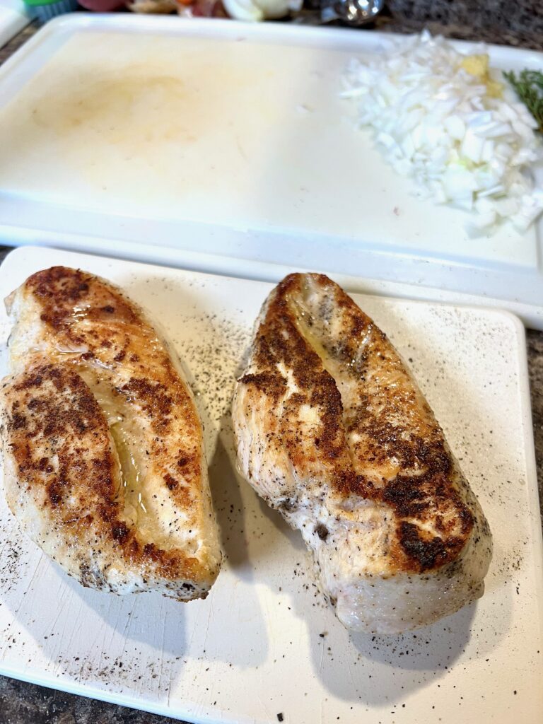 two seared chicken breasts 