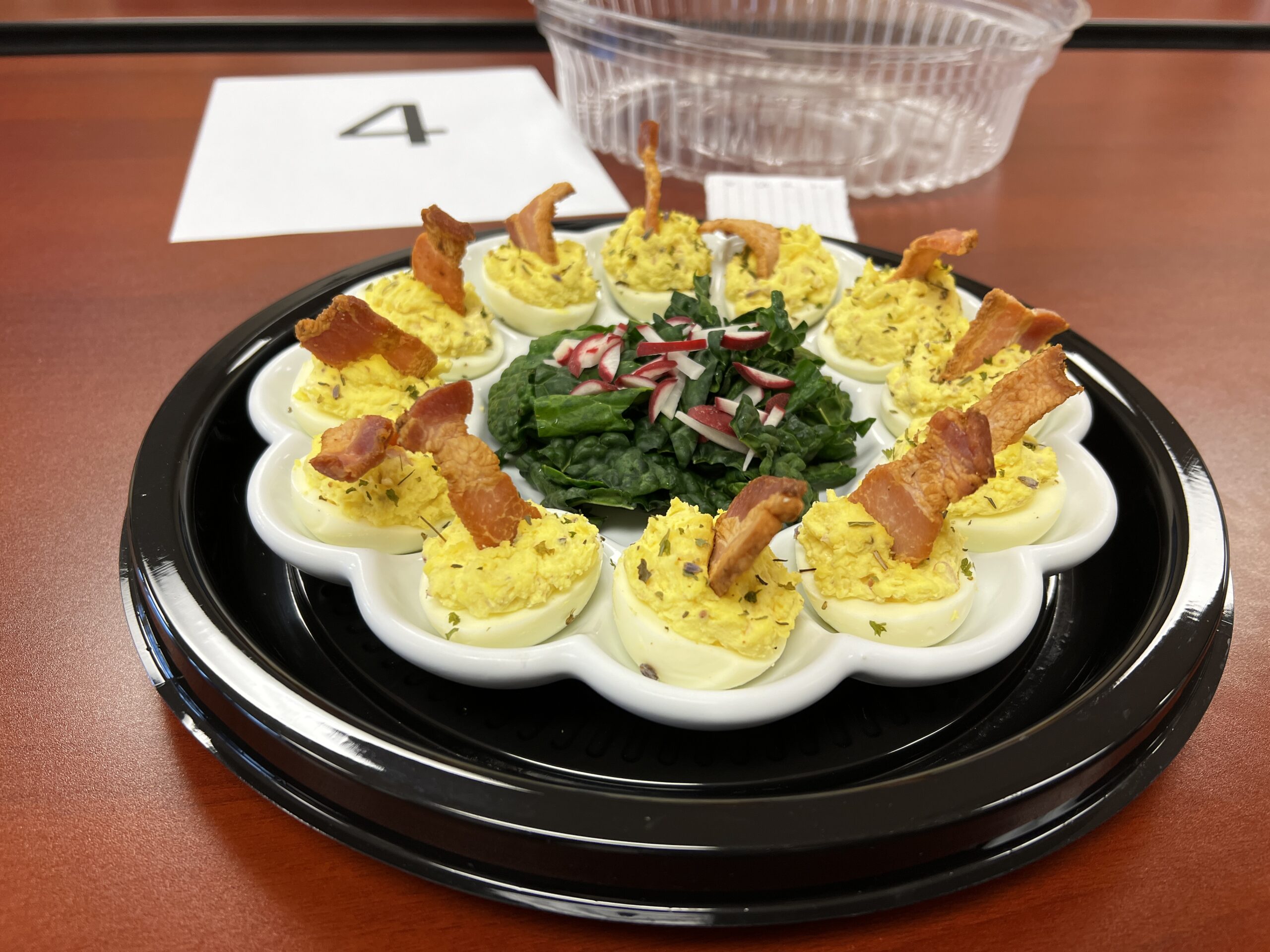platter of deviled eggs topped with bacon at recipe contest 