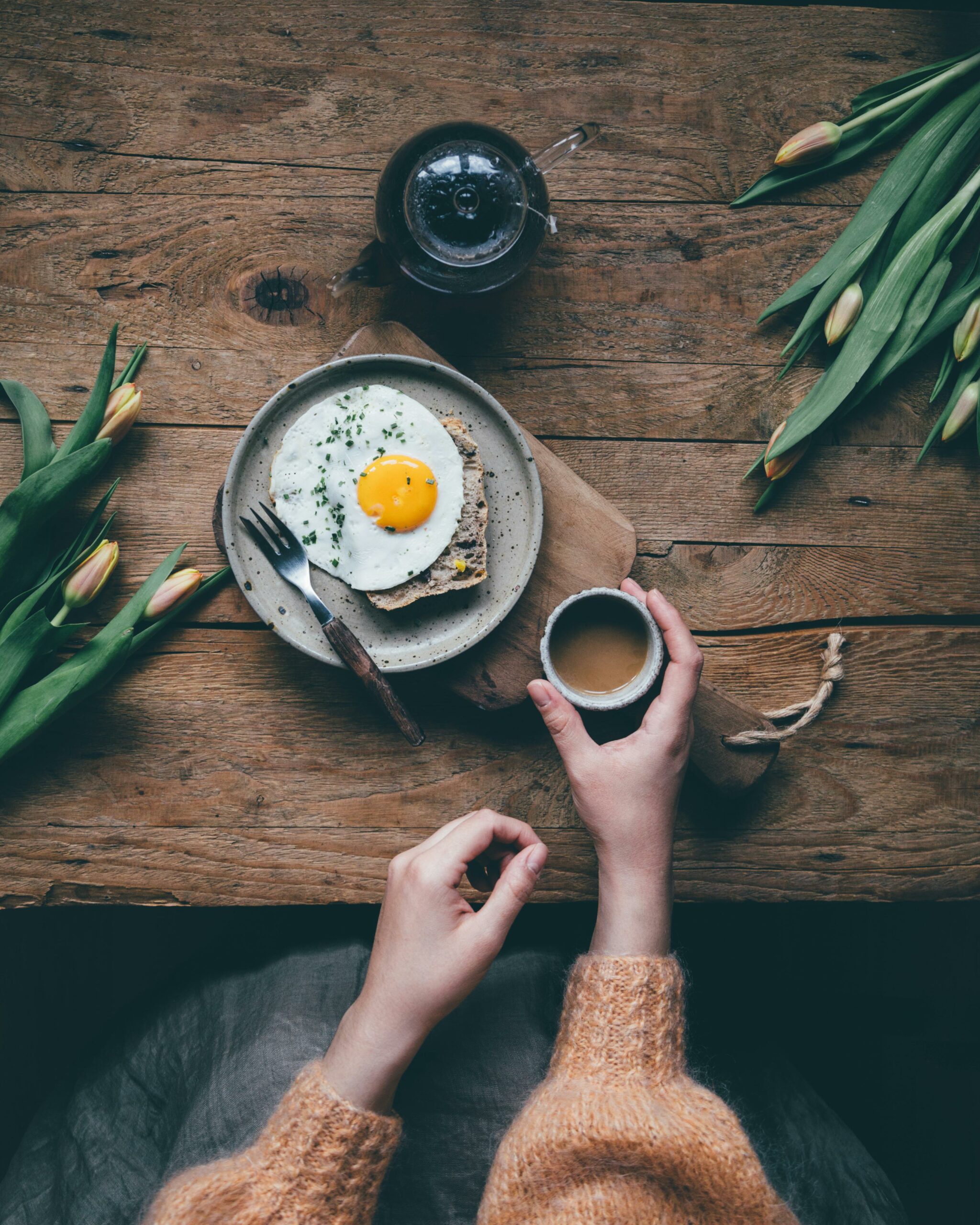 woman eating breakfast drinking coffee