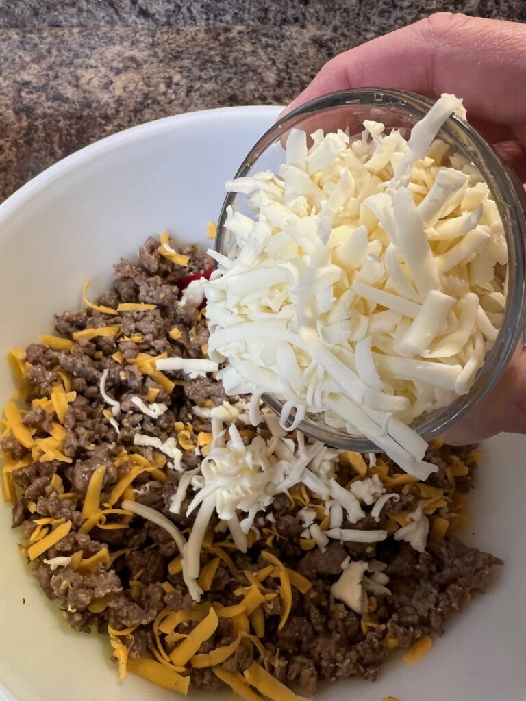 adding the shredded Monterey Jack cheese into the bowl