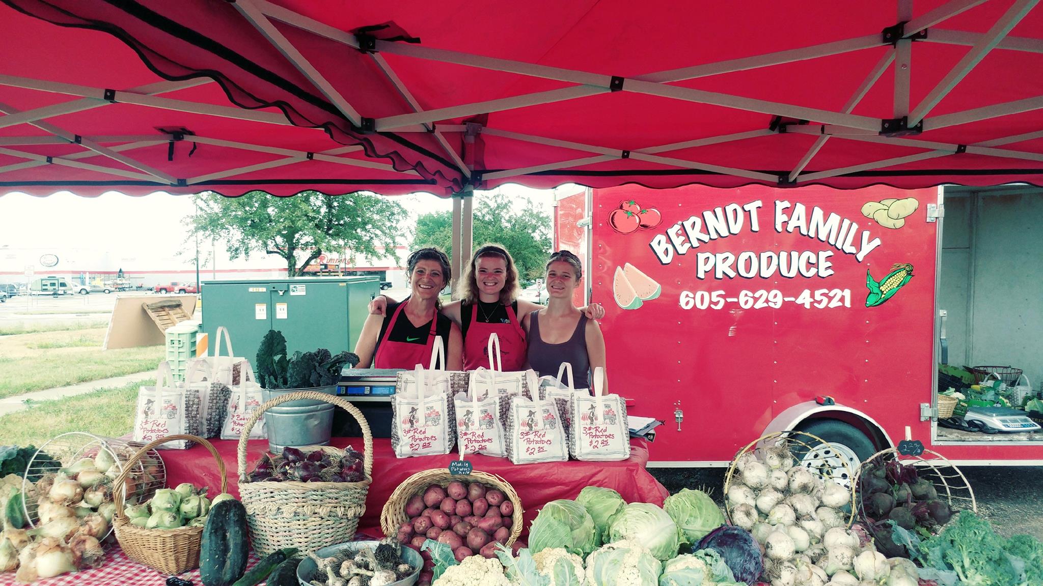 Dawnna Berndt and staff in front of their vegetable farm stand