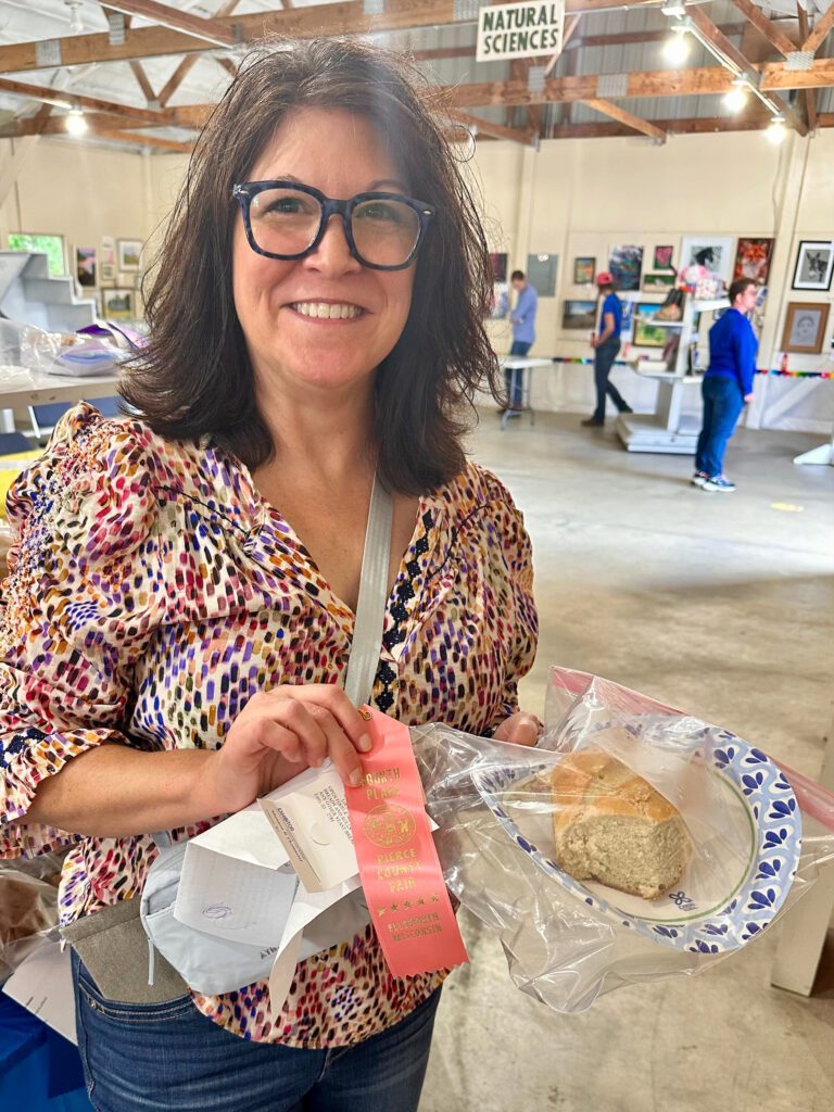 Shannon at the Pierce County Fair with pink ribbon and French bread