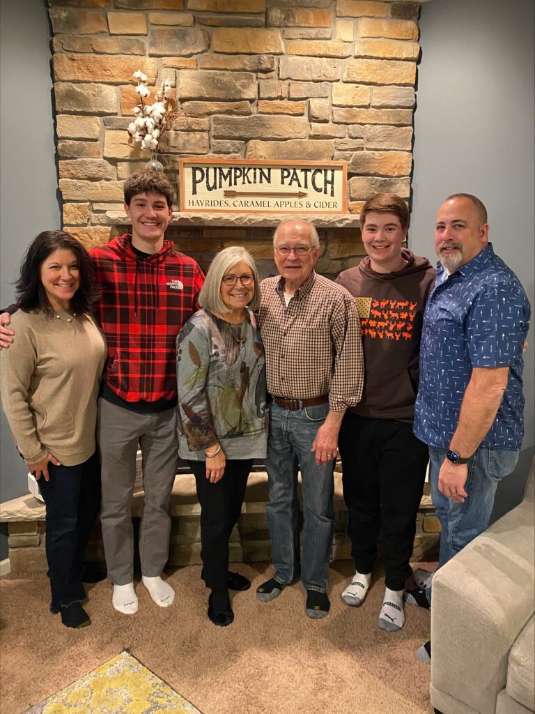 family in front of fire place 